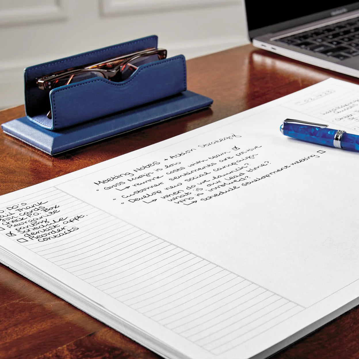 A Circa disc‑bound notebook open beside a ring‑binder planner, showing the difference between discs and rings on a modern work desk with a laptop and pen.