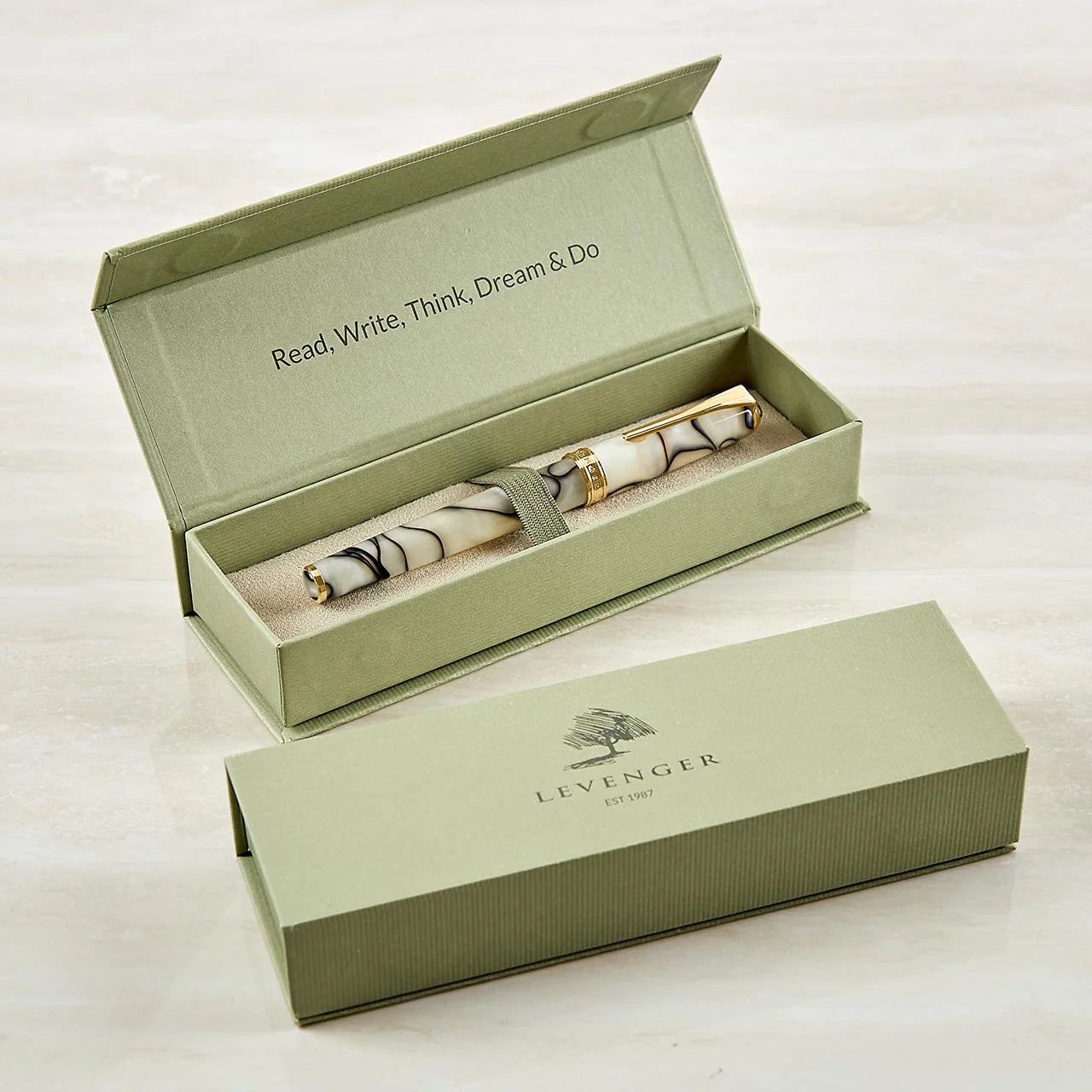 A selection of Levenger leather folios and Circa covers arranged with a logo proof, gift boxes, and personalized cards—an organized view of a corporate gifting order.
