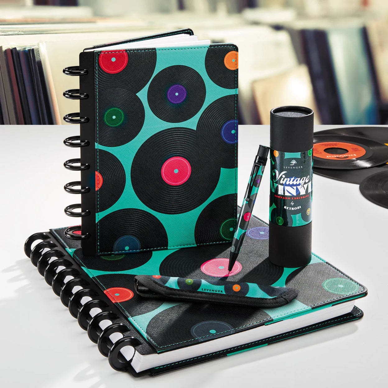 A tidy weekend desk scene: a monthly desk pad with the coming month outlined, a Compact Circa notebook open to the next week, and a pen placed diagonally across the page.