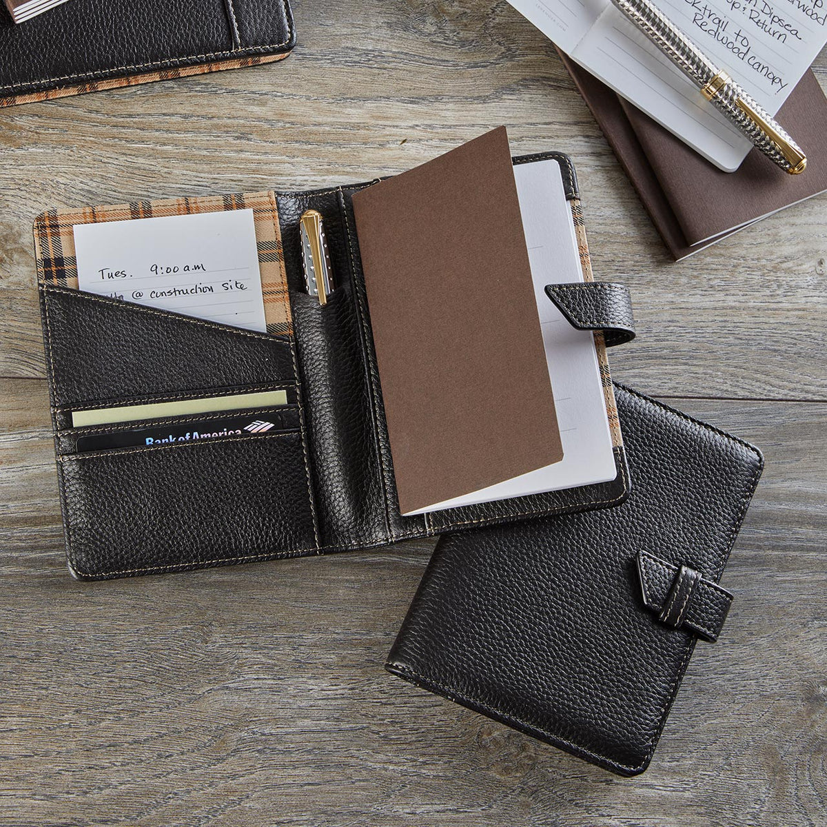An elegant, clutter-free desk with a centered laptop, a slim file holder, a leather catchall tray, and a classic rolltop organizer—bathed in warm afternoon light.