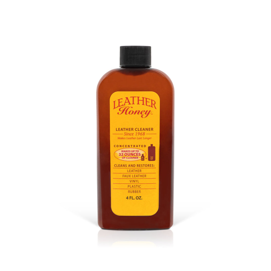 Leather Honey leather cleaner bottle, amber plastic jug with a black screw cap and a bright yellow label.